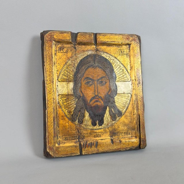 A rare and evocative Orthodox sacred icon painted on wood depicting Christ Pantocrator, accompanied by a period appraisal...