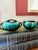 A striking mid-century Blue Mountain Pottery creamer and sugar bowl set in a deep emerald green drip glaze over a near-...