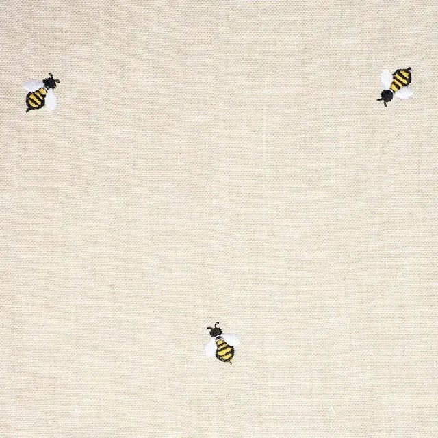 Buzzing with style, this sweet, non-directional design features diminutive honey bees delicately embroidered on a linen...