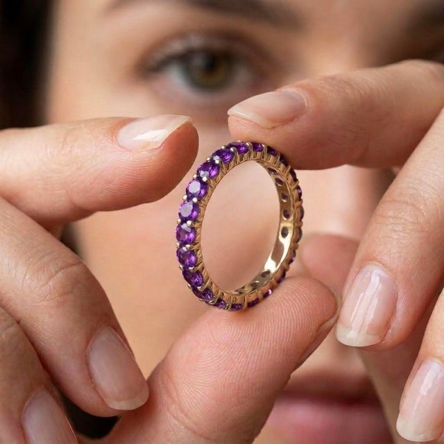 Indulge in the regal beauty and rich, velvety hues of this stunning full-eternity band. Masterfully crafted with an...