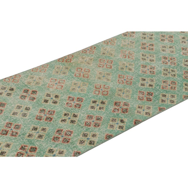 This vintage runner rug is a 3x9 Turkish distressed piece, made with hand-knotted wool circa mid-20th century. It is an...