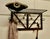 French Art Deco iron hat and coat rack with shelf decorated with roses. This Art Deco period piece coat rack includes a...