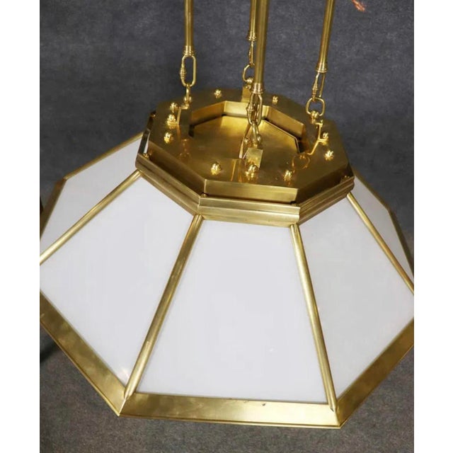 Large Deco inspired hanging chandelier by Ralph Lauren. Milk glass panels set in the geometric shaped hood. Eight medium...