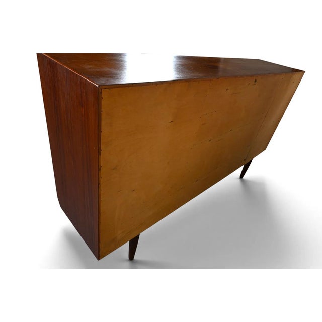 A Danish teak high sideboard by Vejle Stole Møbelfabrik, offering an expansive cabinet form in warm-toned wood. Its long...