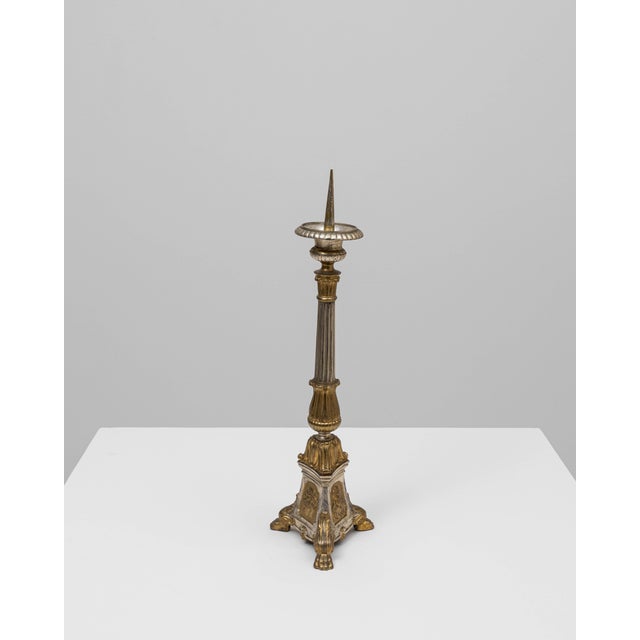 This 19th Century French metal candlestick features a richly detailed silhouette that reflects the ornate decorative...