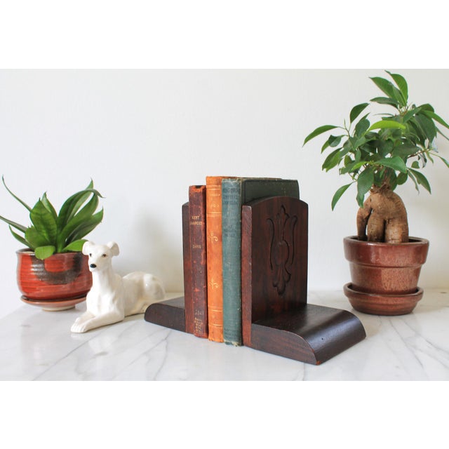 Vintage hand tooled arts and crafts oak wood bookends featuring carved floral design. No makers mark. Some age wear to...