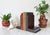 Vintage hand tooled arts and crafts oak wood bookends featuring carved floral design. No makers mark. Some age wear to...