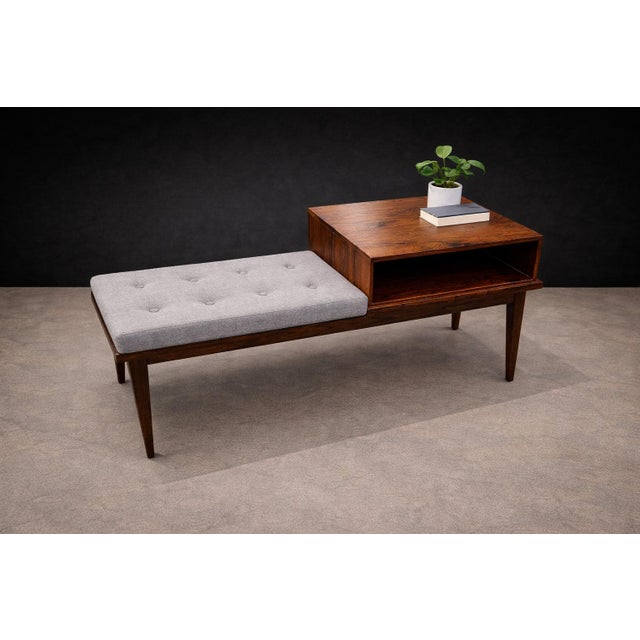 This side table with integrated bench and storage reflects the adaptable, multifunctional approach typical of mid-century...