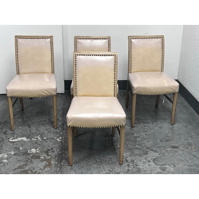 Design Plus Gallery presents a Set of Four Vintage Art Deco Dining Chairs. The chairs evoke the style of Jean-Michel Frank...