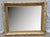 Stunning vintage light gold wall mirror in a Hollywood Regency Neo-Classical style, crafted in the early 1980s. This piece...