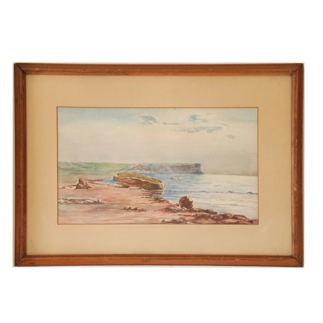 A beautifully painted serene coastal scene with gorgeous coloring. Displayed behind glass in a slightly worn beige mat and...