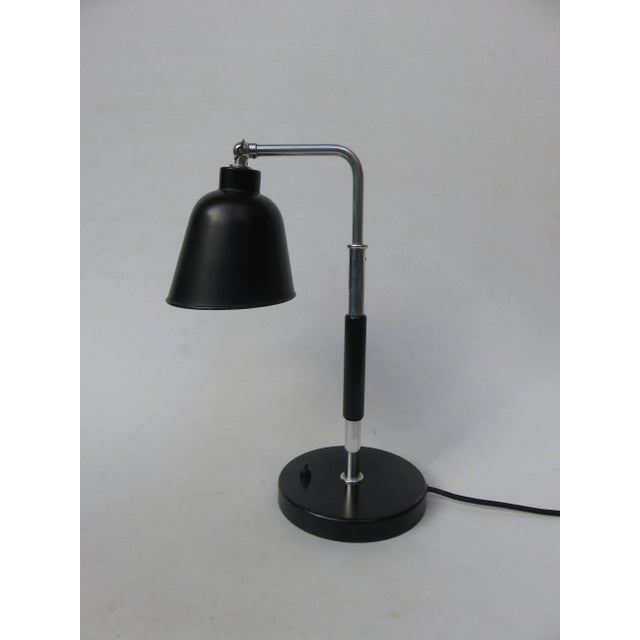 This Goethe lamp is attributed to Bünte & Remmler and was designed by Christian Dell. The arm can be swiveled 180° and the...