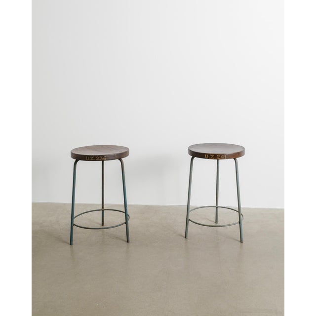 A rare pair of French mid century modern high bar stools in a blue decorative lacquered with a dark stained teak seatings...