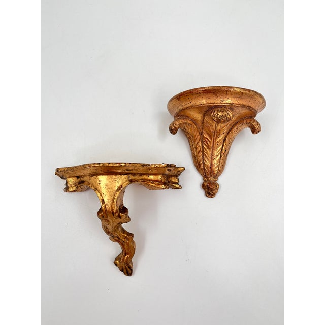 Gorgeous curated set of 2 Italian gilt wall shelves, brackets, or plinths. Each piece features ornate Florentine carving...