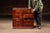 Two-tier oak filing cabinet with four equal drawers, each fitted with brass label holders and pulls. The case presents a...