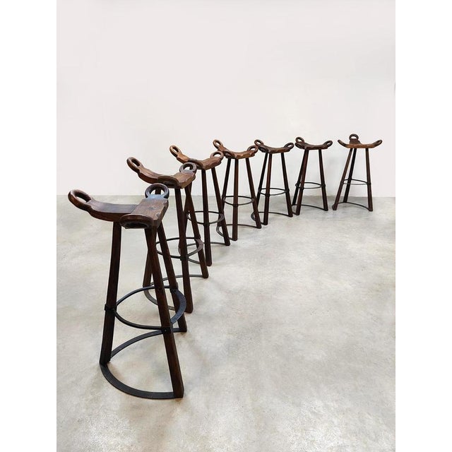 These sturdy stools are slightly different than usual because of their metal foot ring at the bottom that resembles a...