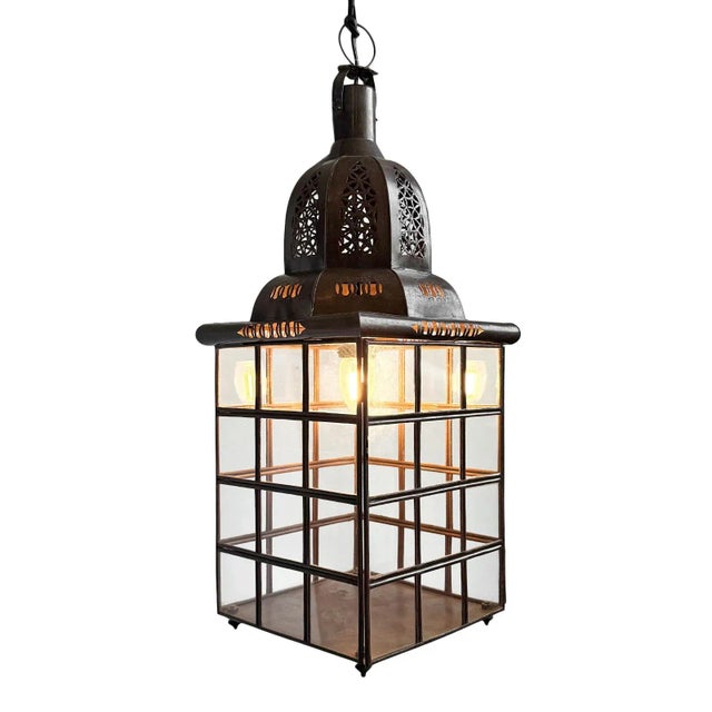 Beautiful vintage iron and glass windowpane pendant lantern. Hand cut decorative perforation details at top. Includes 3'...