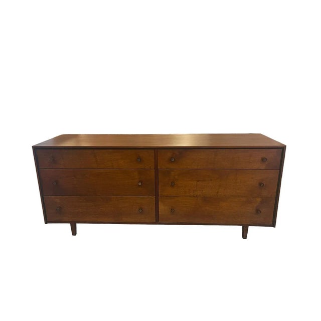 This Dresser features original wood and metal hardware. Dovetailed Drawers. The frame,handles and legs are accented with...