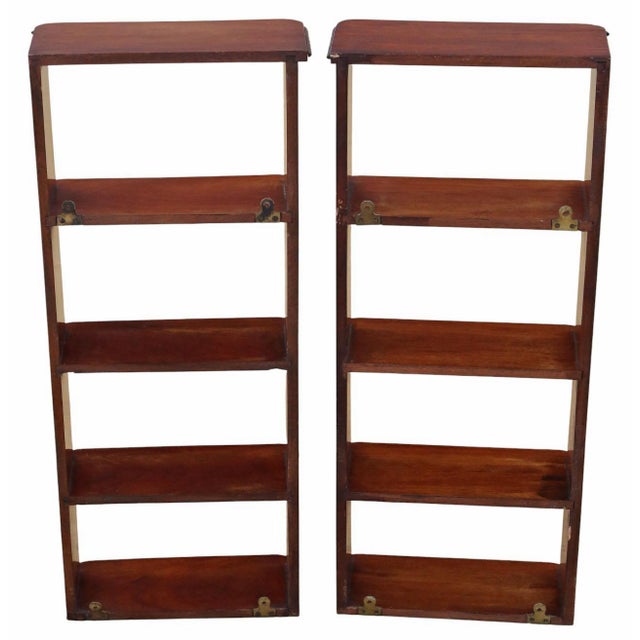 A pair of early 20th-century mahogany wall bookcases with attractive age, colour, and patina. Full of authentic charm and...