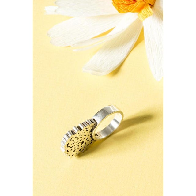 Silver ring by Cecilia Johansson, decorated with a cluster of silver spheres, building upwards in a singular, towering...