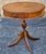 A George III Style Mahogany Two-Drawer Drum Table on quad-leg pedestal terminating with brass cap paw feet. Measures 26"...