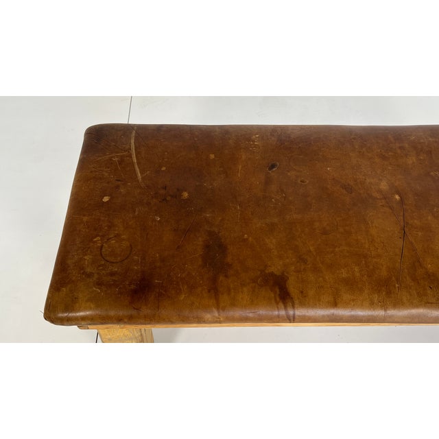 Decorative vintage gymnastic bench from the 1940s and 1950s. The robust cowhide leather and oak wood have a distinctive...