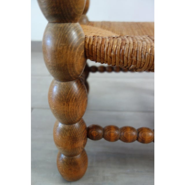 Brutalist low chair attributed to Charles Dudouyt, dating from the 1950s/60s. Solid oak frame, coil-turned. Original straw...