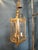 A classic French Louis XV–style brass hall lantern featuring a cylindrical form with gracefully curved glass panels and...