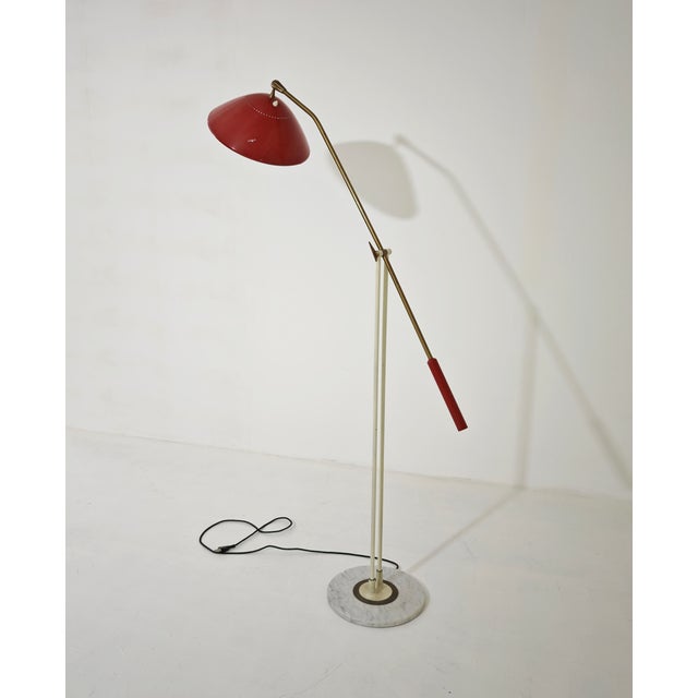 This iconic balance floor lamp was designed and produced by Stilnovo in Italy in the 1950s. It features a brass and red...