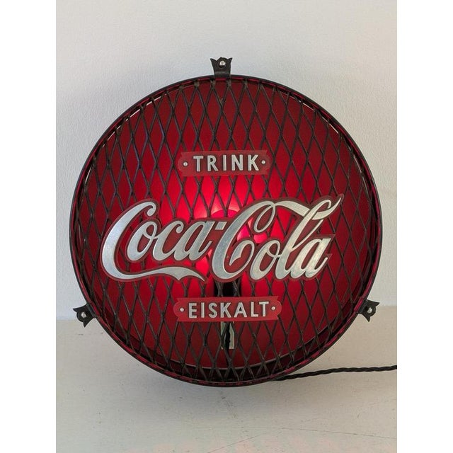 An unusual lighting fixture made from original Coca-Cola advertising: This round advertising grid was transformed into a...