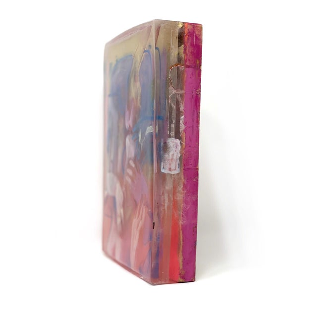 This artwork portrays an intimate embrace, where figures intertwine in a dynamic interplay of color and form. The layered...