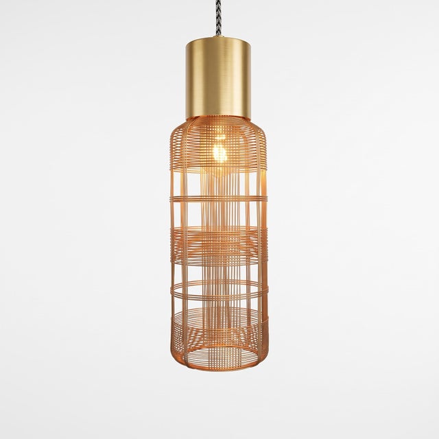 This handwoven galvanized iron pendant light wraps a slender oval cage around an elongated inner diffuser, finished with a...