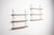 This elegant pair of vintage wall shelving units combines minimalist design with clever engineering. Crafted with warm...