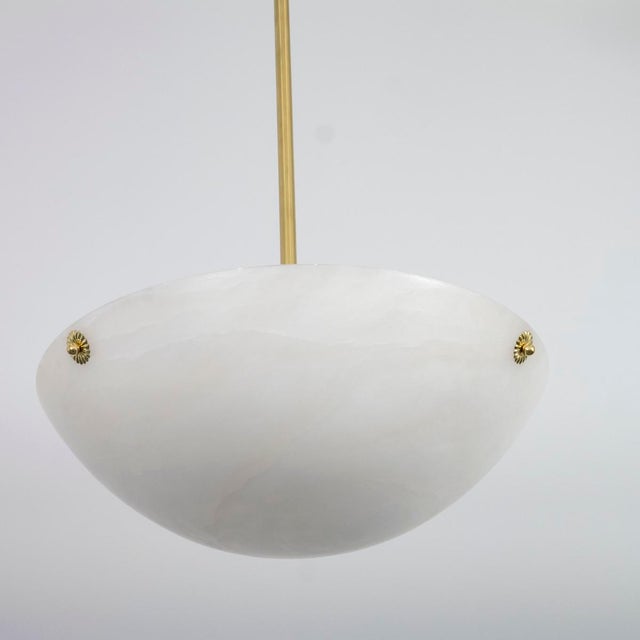 Spanish alabaster dome pendant with brass floral hardware details.