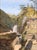Gorgeously detailed mountain landscape by an unknown Japanese artist (19th Century). Two waterfalls cascade down a lush...