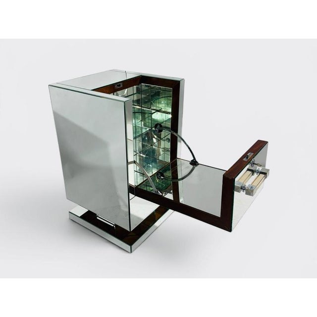 A magnificent French Art Deco bar cabinet from the 1930s, attributed to Jacques Adnet, of exceptional quality and...