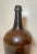 Up for sale is a large antique 19th century hand blown glass demijohn wine bottle. It's blown by hand out of thick green...