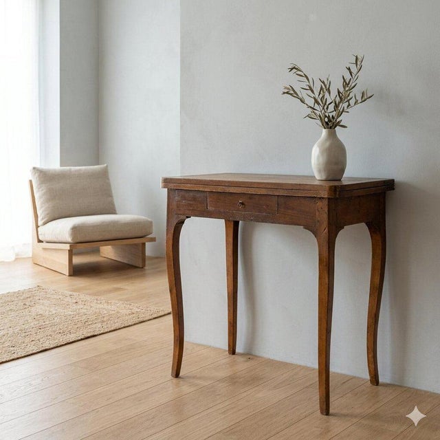 Walnut and poplar game table with maple trim. Fold-down top rests on a tilting right rear leg. Drawer under the top,...