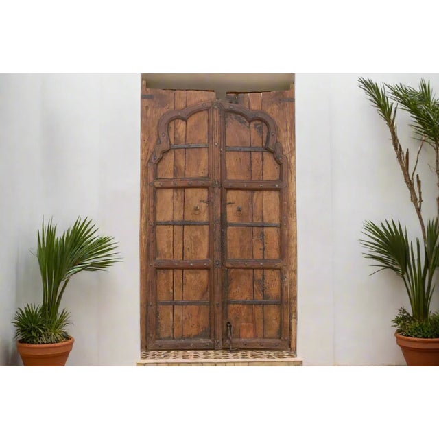 This antique Indian door is a testament to ancient craftsmanship was made from robust teak panels. The front of this...