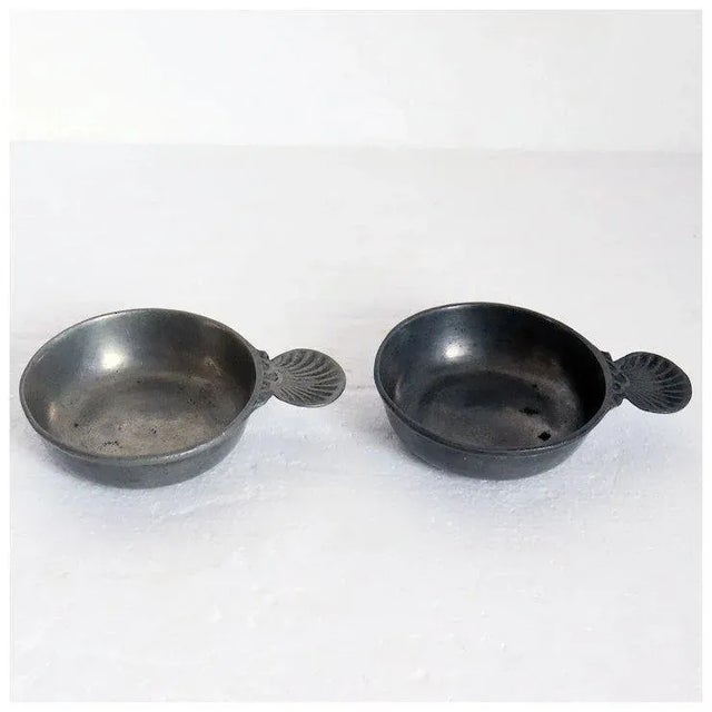 DETAILS A pair of shell handle shallow round bowls. This form of small, shallow, flat handle bowl was traditionally used...