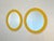 Pair of round mirrors from the 1970s, yellow lacquered wood