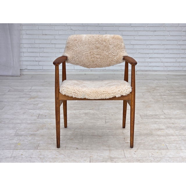 1960s, Danish design by Erik Kirkegaard, model 43. Reupholstered in quality genuine New Zealand sheepskin "Canberra". Oak...