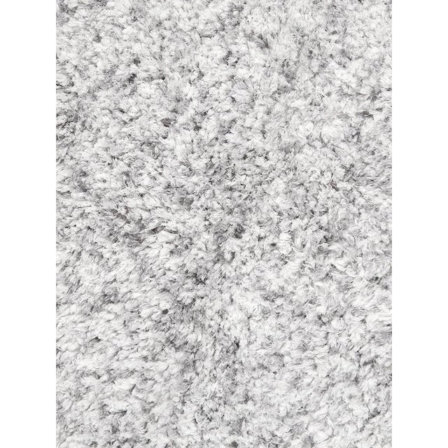 Add irresistible softness to your floors when you cover them with this luxurious Shaggy rug. This soft colored area rug...