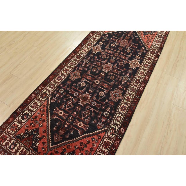 An authentic semi-antique tribal Hamedan runner hand-knotted with fine wool and natural dyes. This nomadic oriental rug...