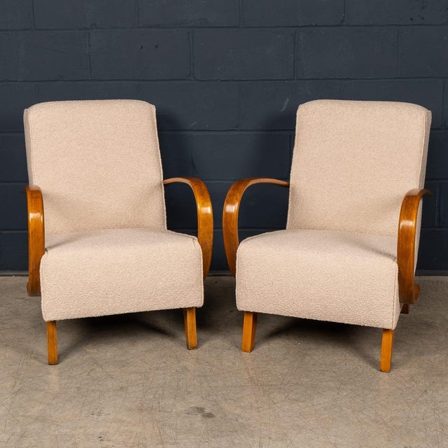 This elegant pair of lounge chairs is designed by Jindřich Halabala, one of the most influential figures of early 20th-...