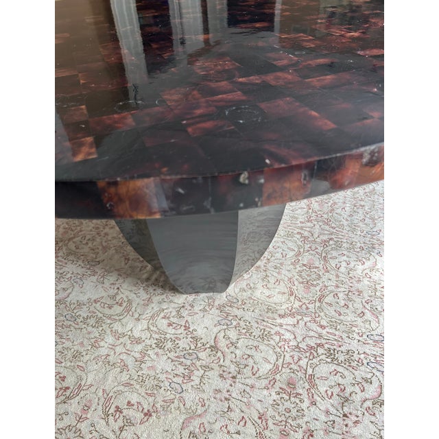 Elegant modern center table having sculptural ebonized wood base and organic tessellated top with checkerboard pattern...