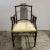 An elegant walnut arm chair with a carved bamboo design attributed to Baker furniture. The chair features comfortable arm...