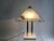 Elegant italien 80s table lamp with triangular glass shades and geometric design. Polished gold-tone columns combined with...