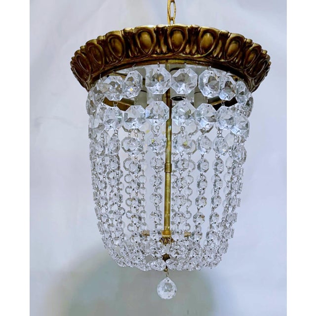 Vintage bronze basket chandelier with 30% leaded graduated octagon crystals. Rewired and restores and it has 3 candelabra...