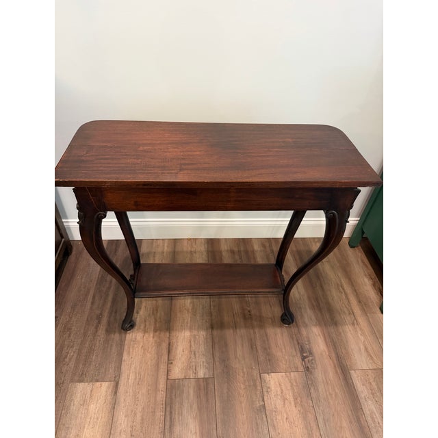 Add timeless elegance to your space with this beautifully crafted vintage/antique-style wooden console table. Featuring a...